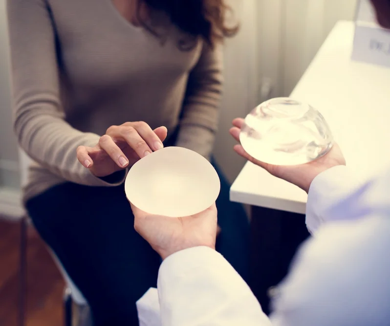 patient looking at breast implants during consultation