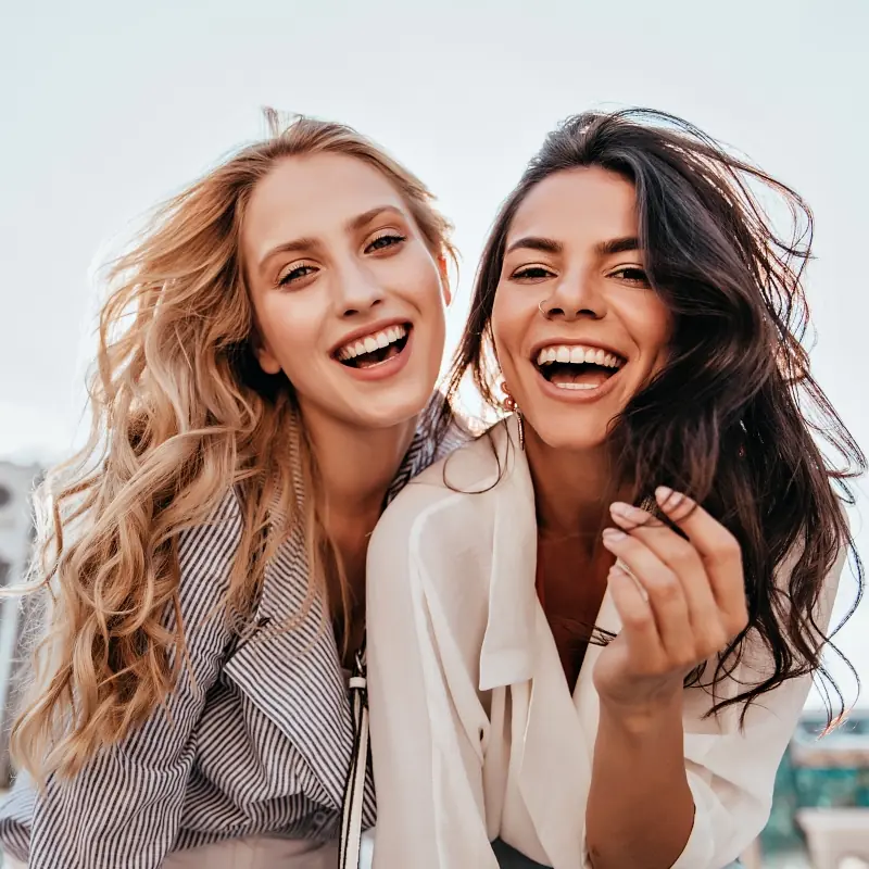 Two diverse friends lauhging