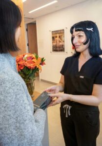 autumn helping a patient at the front desk
