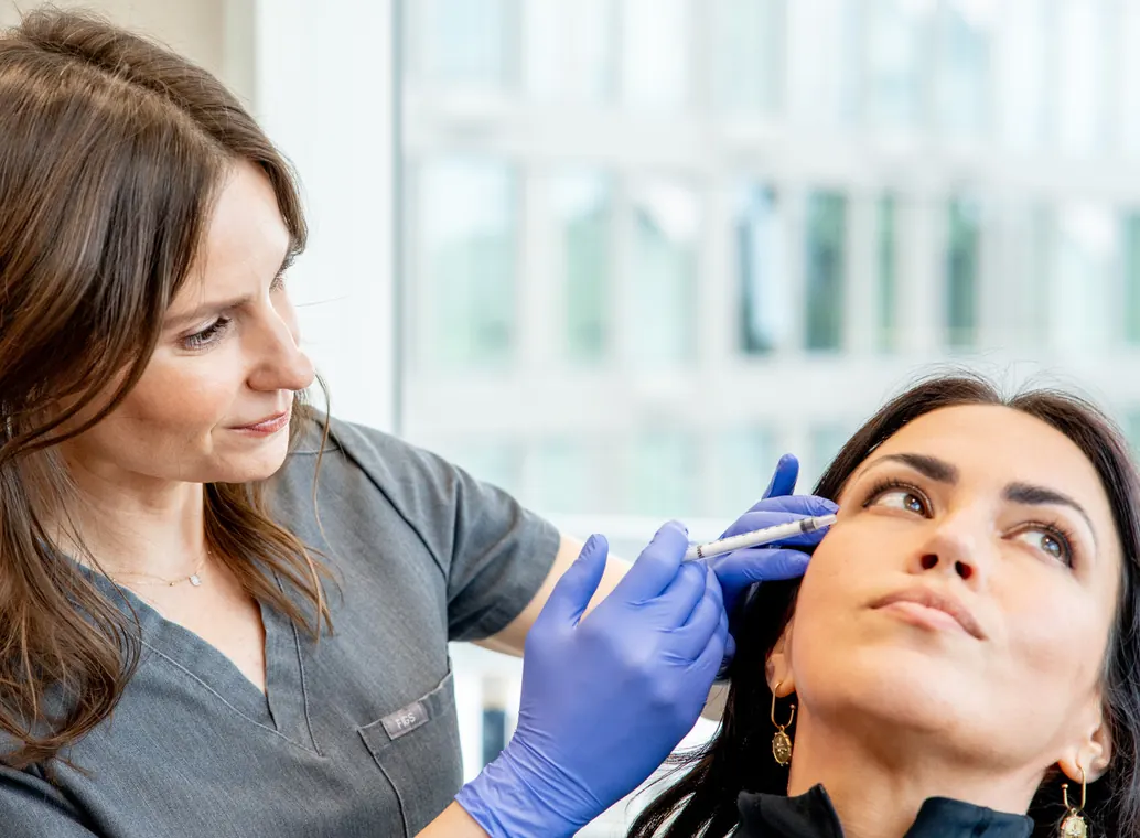 Emily Sespaniak, MSN, NP-C treating client with injectable neurotoxin or dermal filler