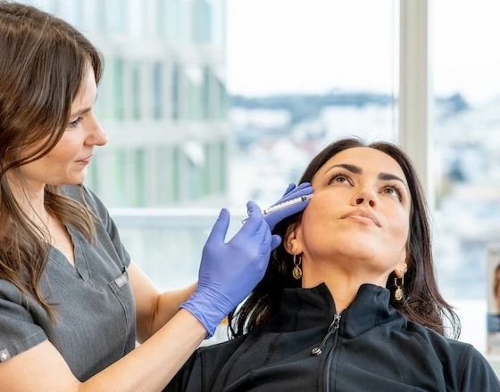 Emily Sespaniak treating client with injectable