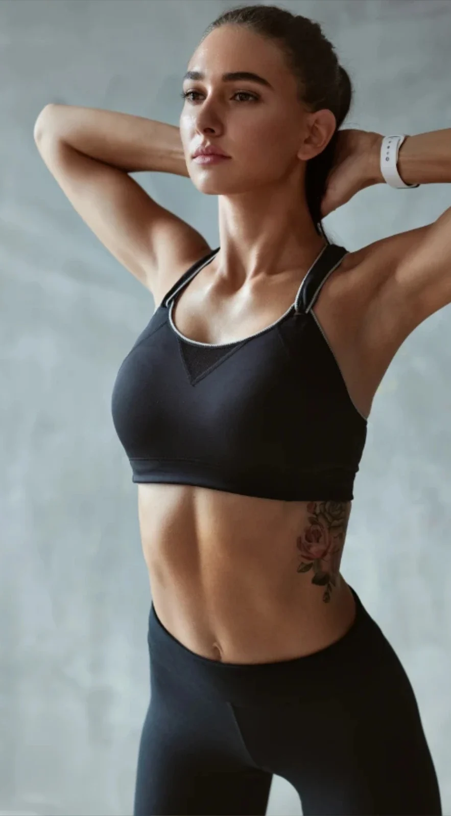 woman in sports bra stretching arms