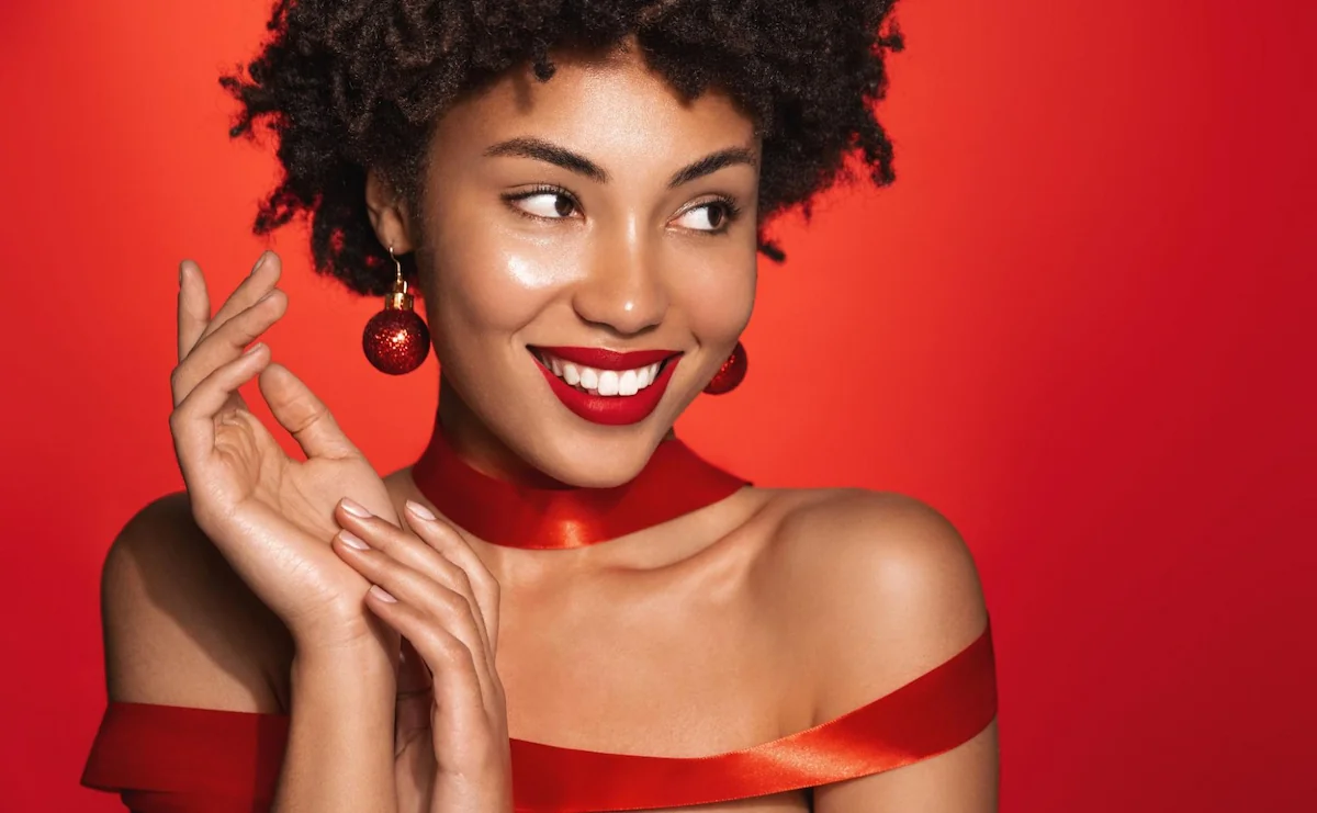 beautiful woman with radiant skin in red festive dress